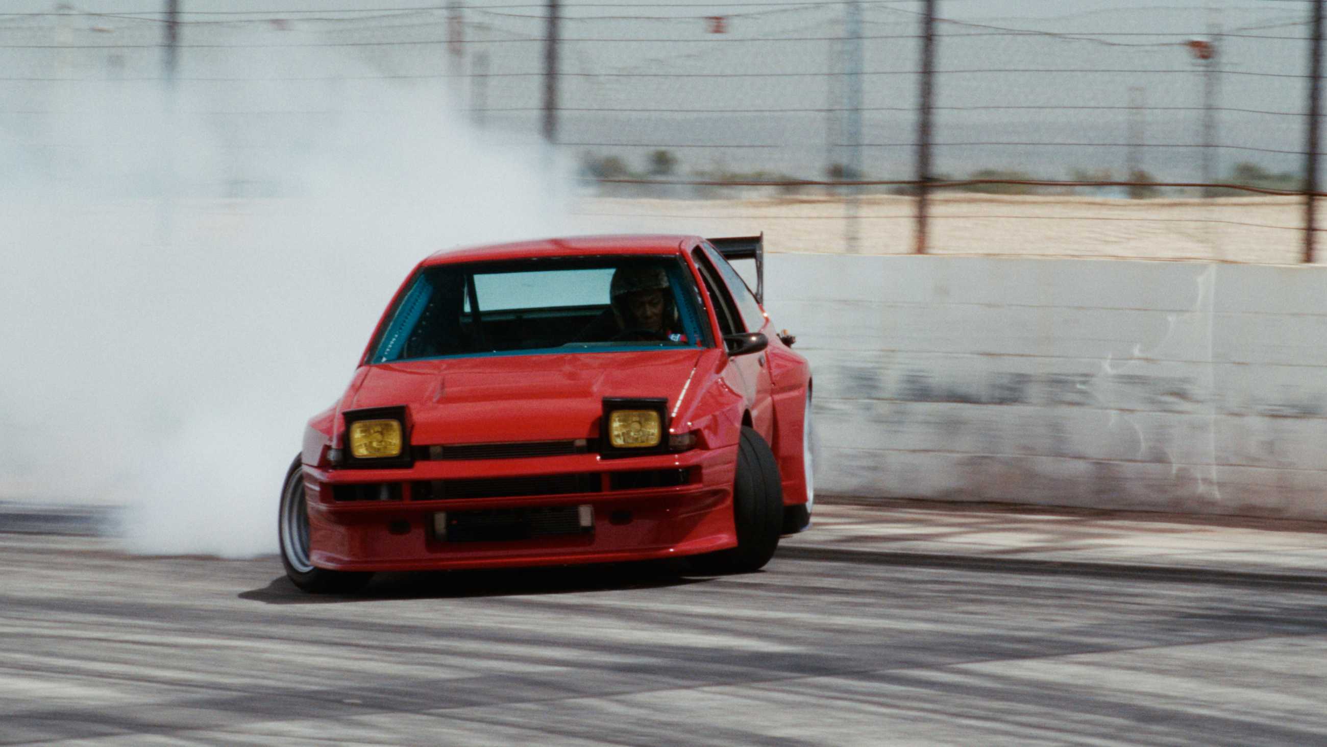 A red car drifting in Drifter