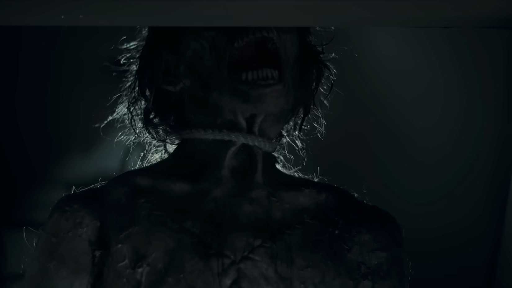 A wounded looking person opening their mouths in The Cycle trailer