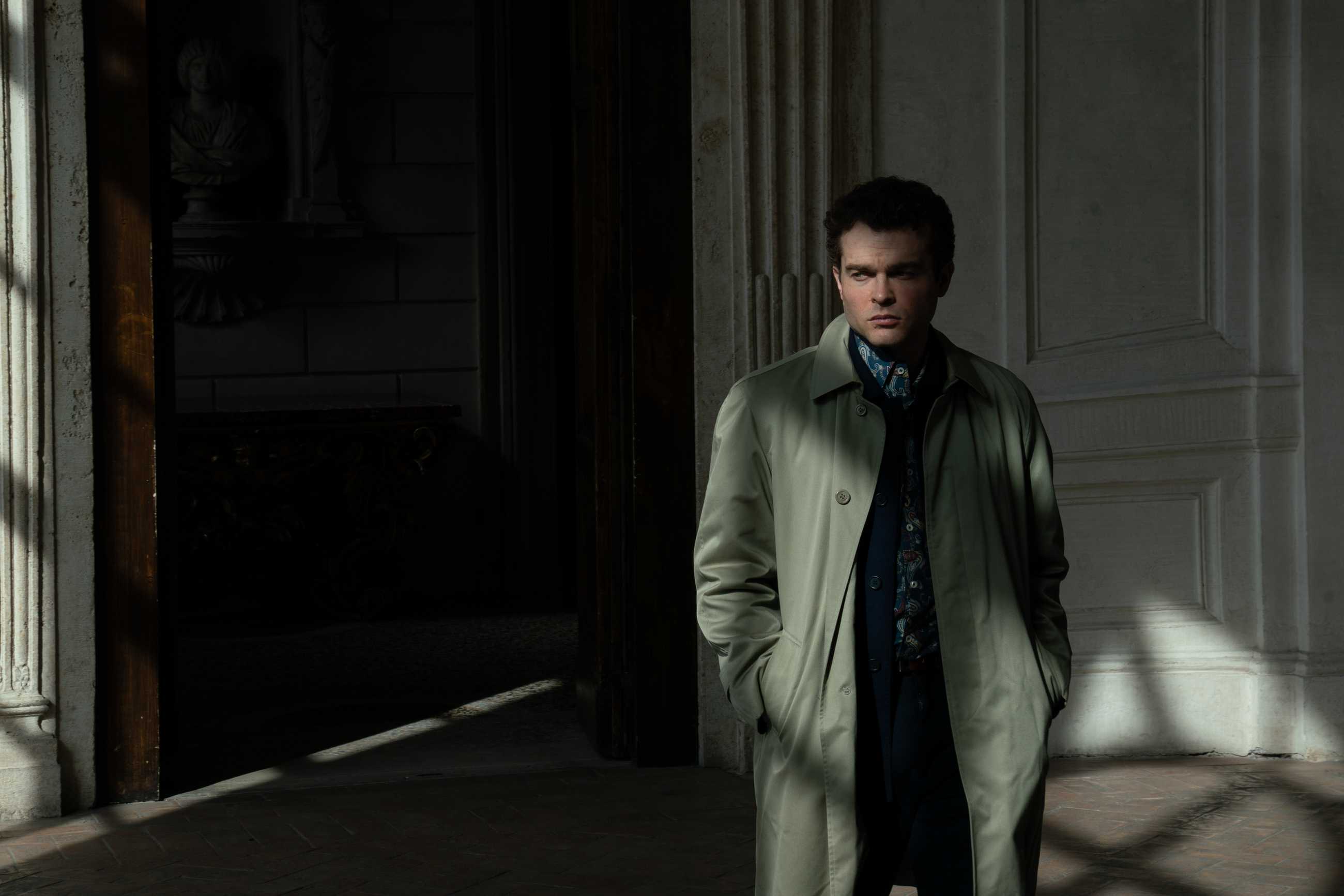 Alden Ehrenreich as Ridgeway lurking in the shadows in A Talent for Murder