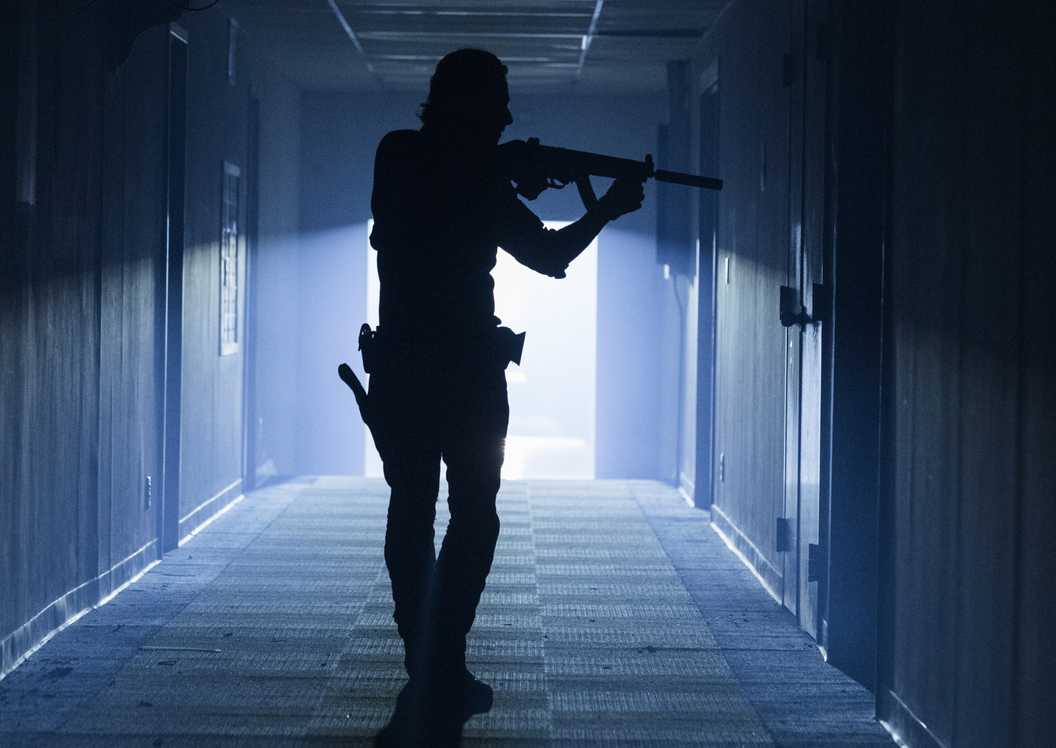 Andrew Lincoln's shadow as Rick Grimes holding u rifle in The Walking Dead season 8