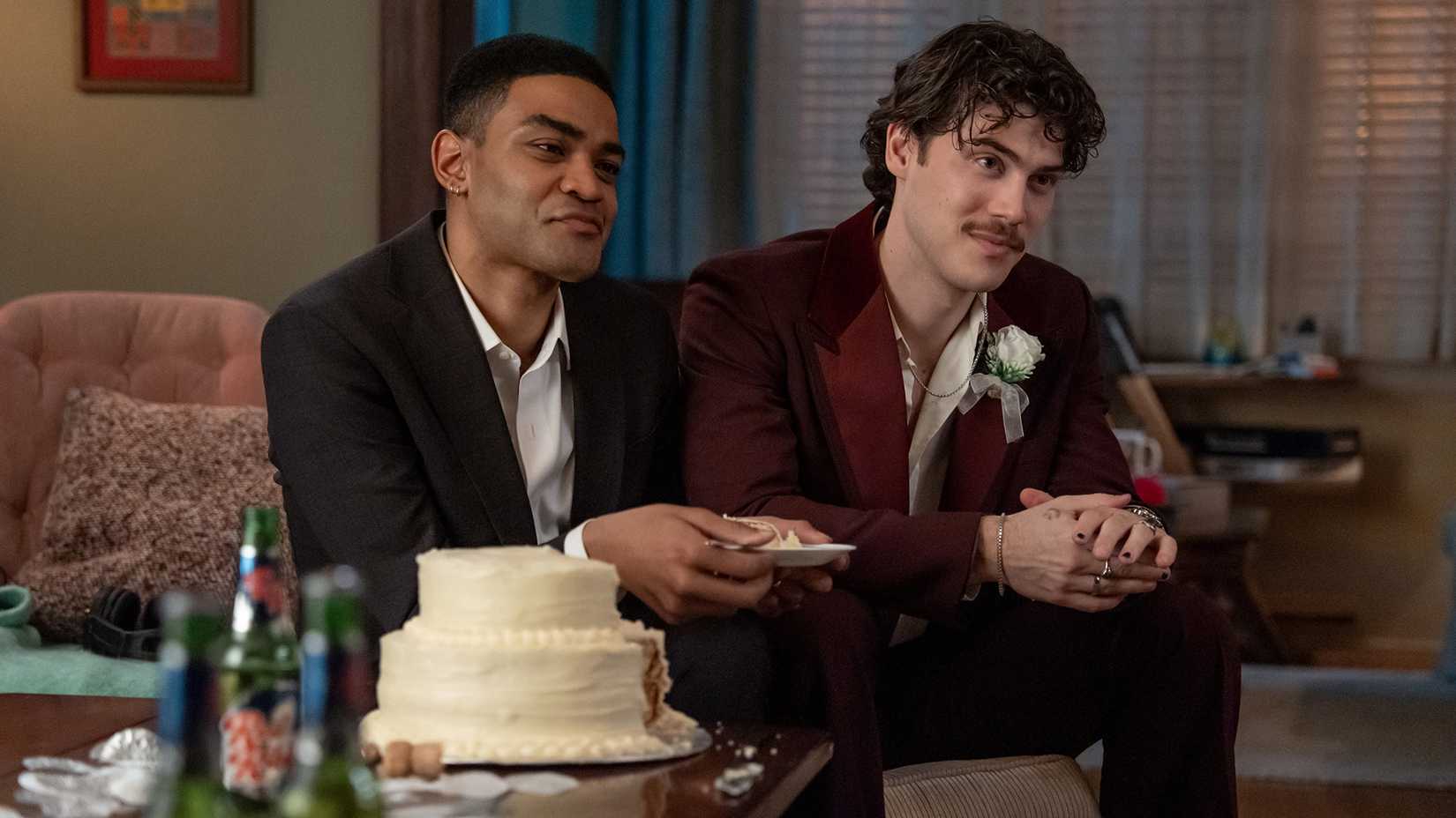 Anton and Paul Baker sitting together in a scene from Adults