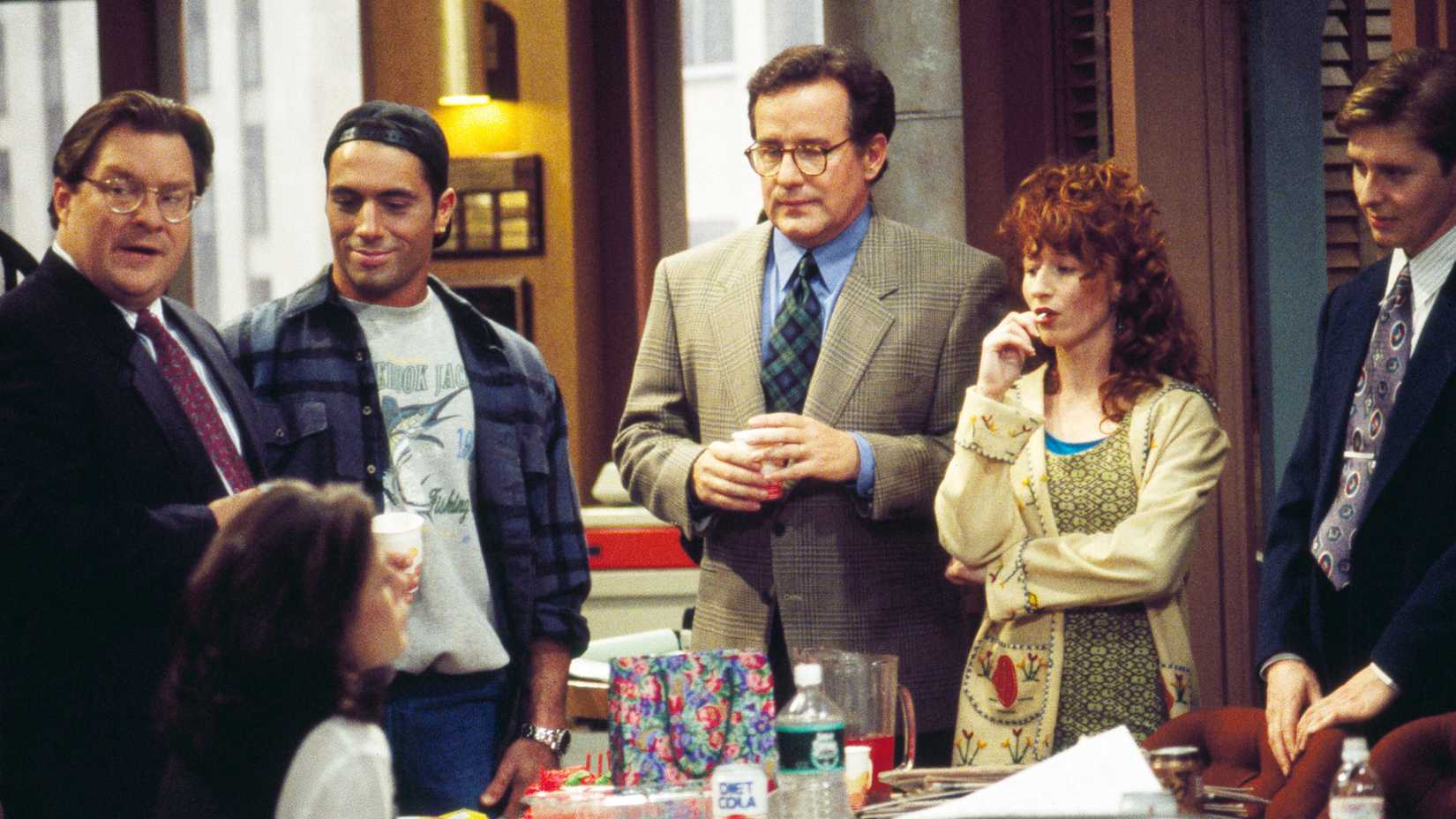 Phil Hartman in a team meeting in NewsRadio