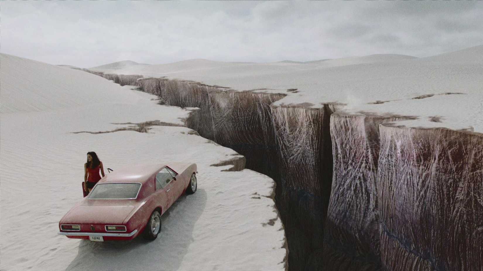 Grace (Christina Ochoa) standing by her car and the ravine in Blood Drive.
