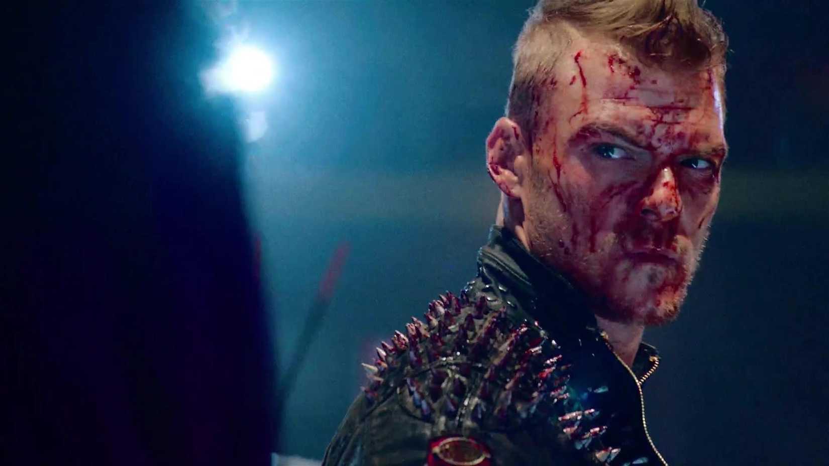 Barbie (Alan Ritchson) covered in blood in Blood Drive.