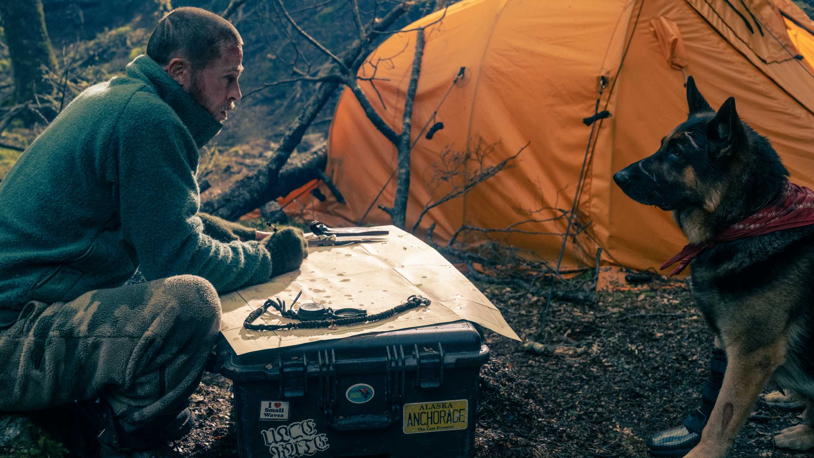Brad Pitt and Odin huddled over a map in Heart of the Beast
