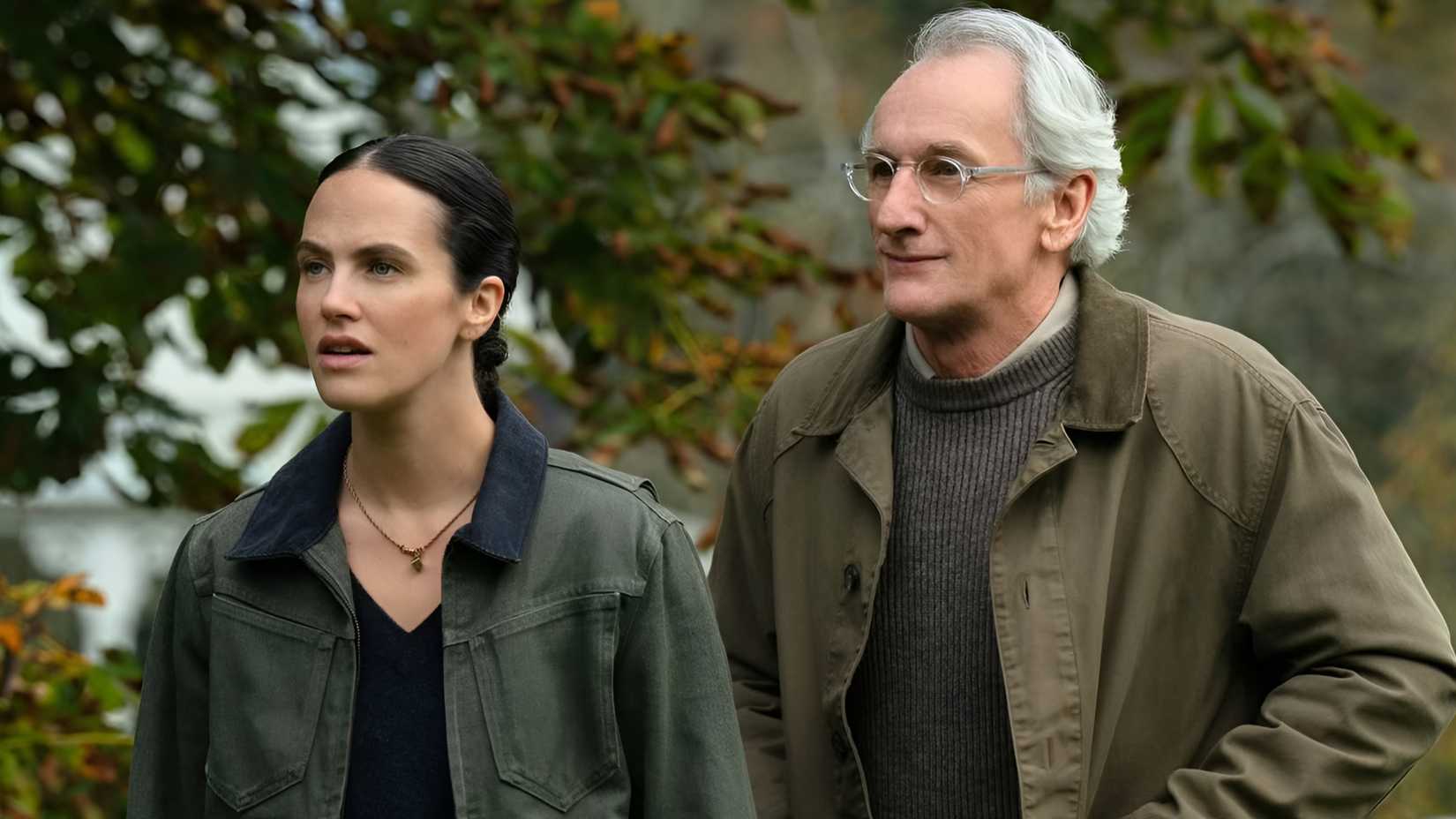 Jessica Brown Findlay’s Charlotte and Matt Craven’s Victor strolling in a park in Silo season 3