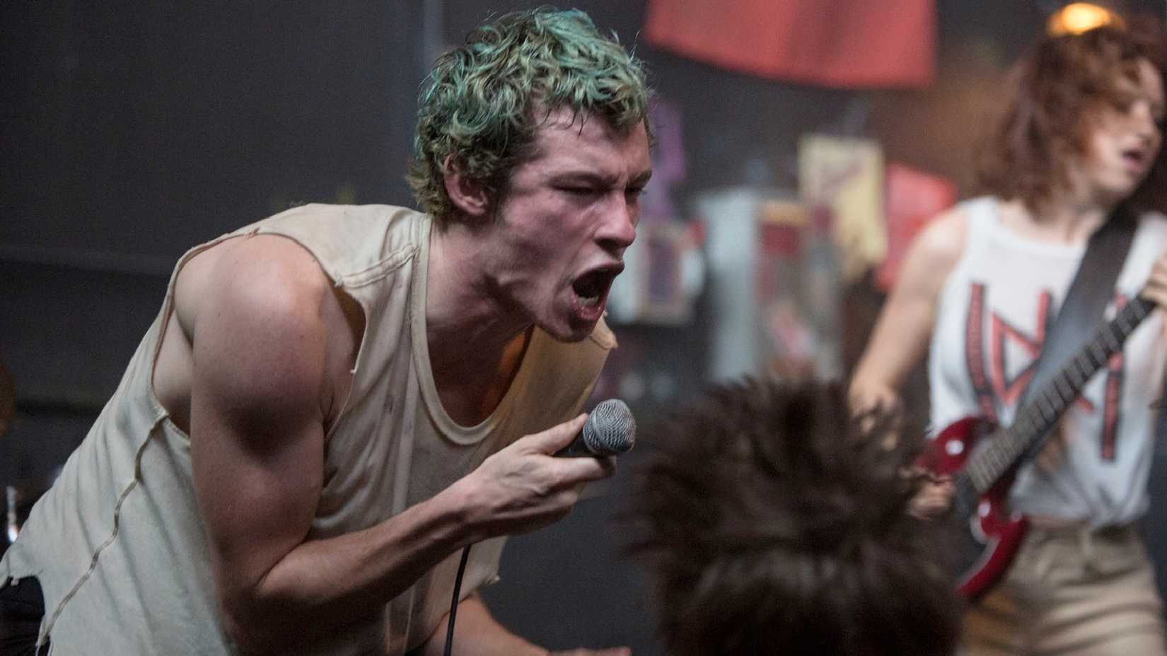 Callum Turner as Tiger singing with the band in Green Room