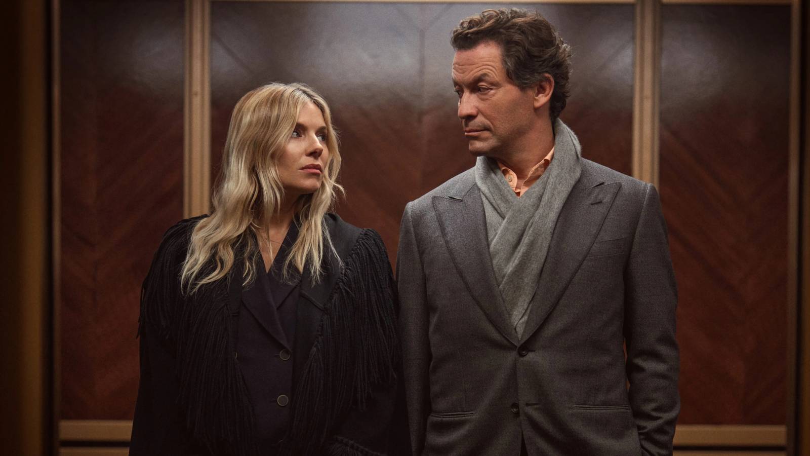 Carla and Morgan look at each other while standing in the elevator in HBO's War