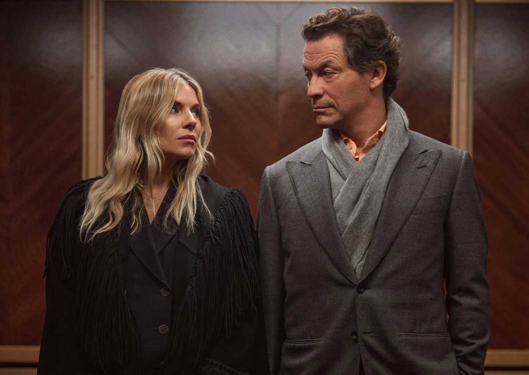 Carla and Morgan look at each other while standing in the elevator in HBO's War