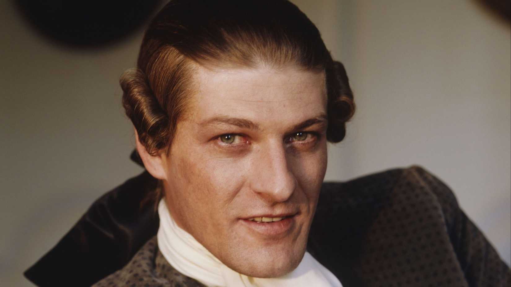 Lovelace (Sean Bean) smirking at the camera in Clarissa.