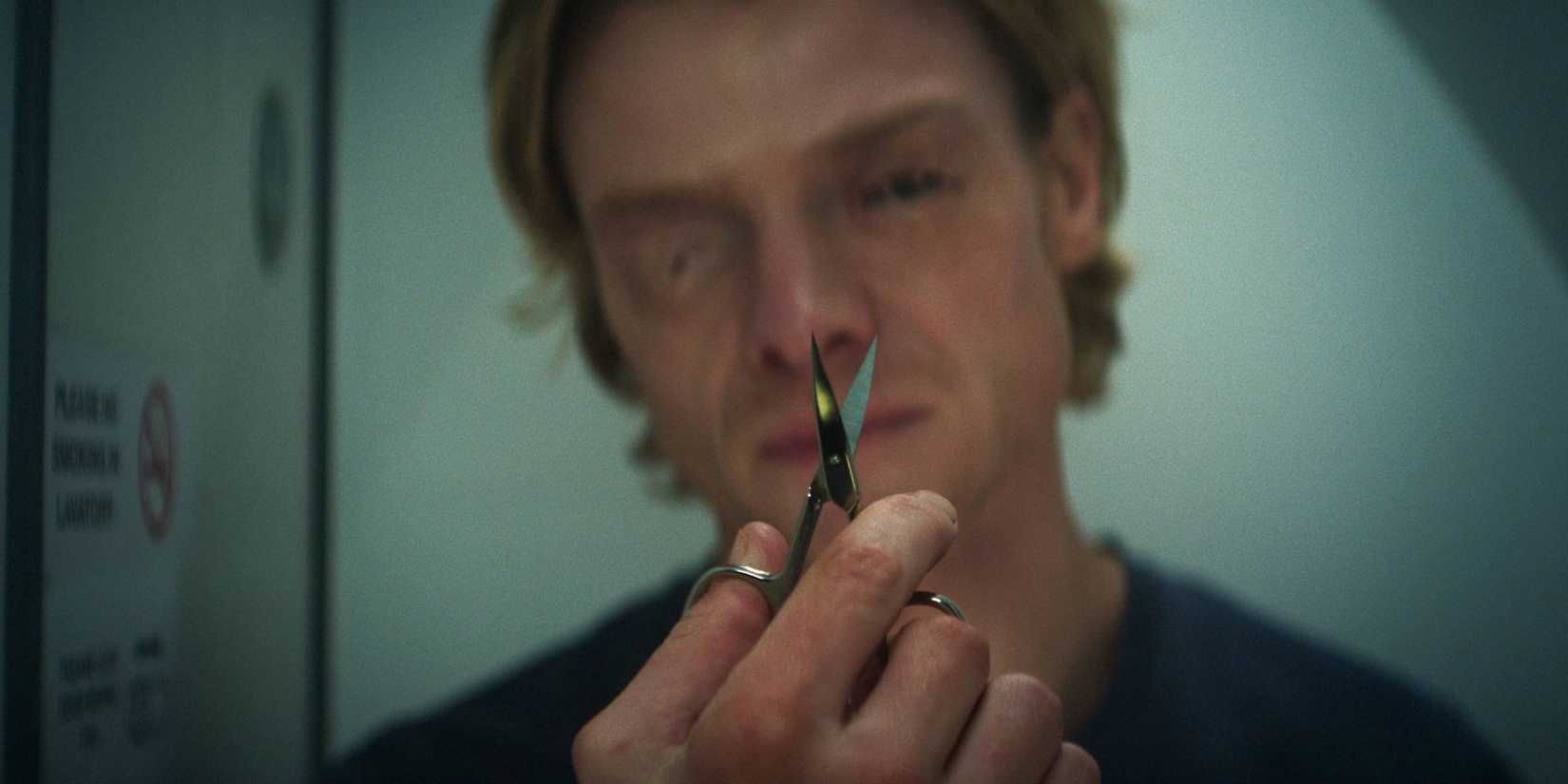 Matt (Tom Rhys Harries) prepares to cut his sealed eyelids in Clayface (2026)