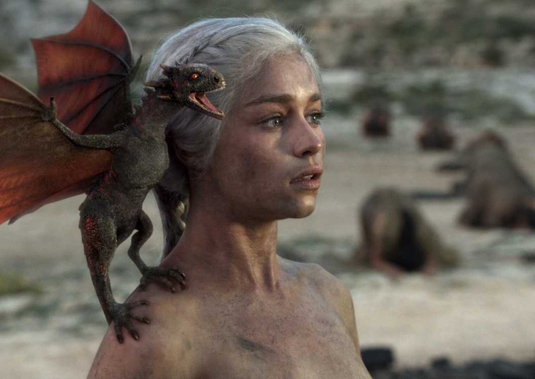 Daenerys with a baby dragon on her shoulder in Game of Thrones