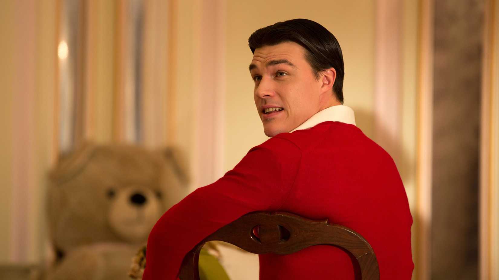Dandy Mott sits on a chair looking over his shoulder in American Horror Story season 4
