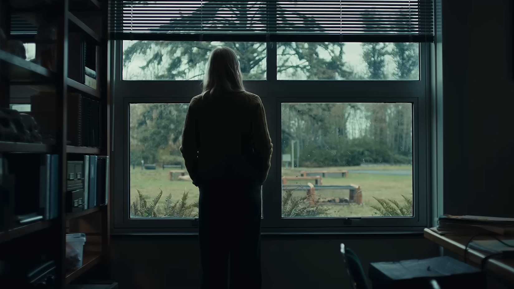 Deborah Ann Woll's character looking out a window in The Cycle trailer