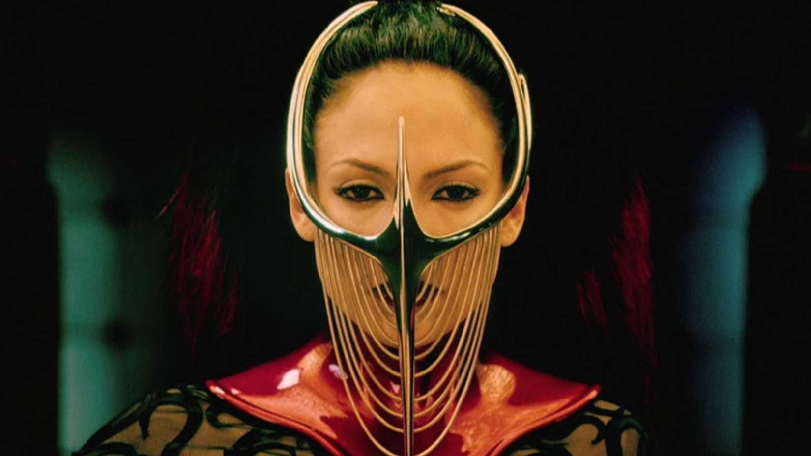 Dr. Catherine Deane in a golden mask looking off-screen in The Cell