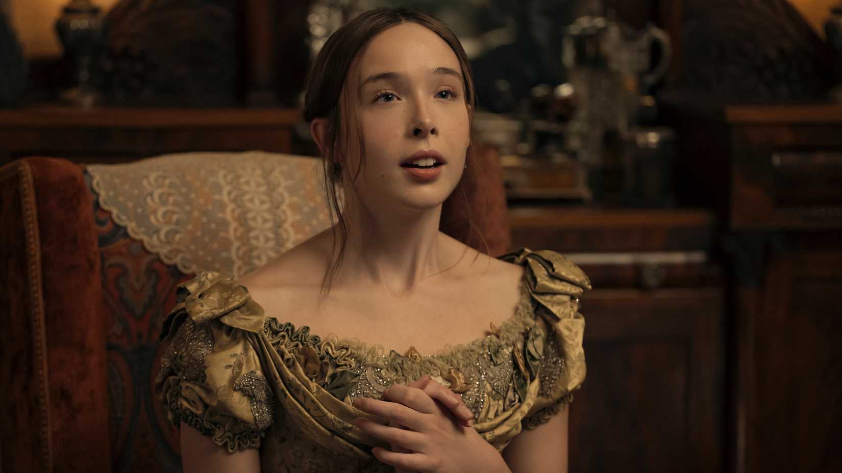 Lizzie Borden sits and clasps her hands together in Monster: the Lizzie Borden Story episode 3