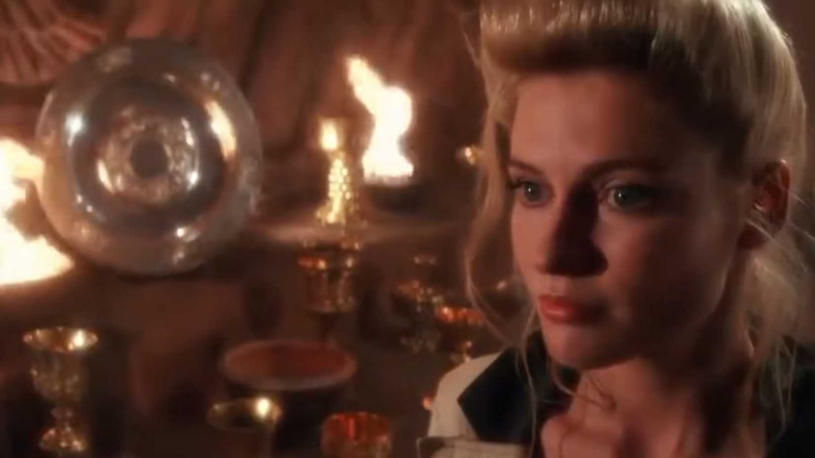 Elsa standing beside false grails in The Last Crusade