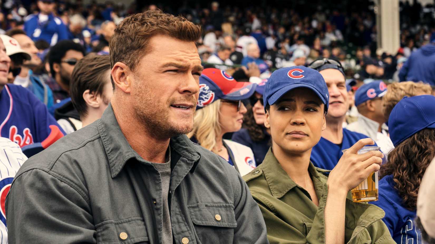 Alan Ritchson’s Jack Reacher and Maria Sten’s Frances Neagley at a baseball game in Neagley season 1