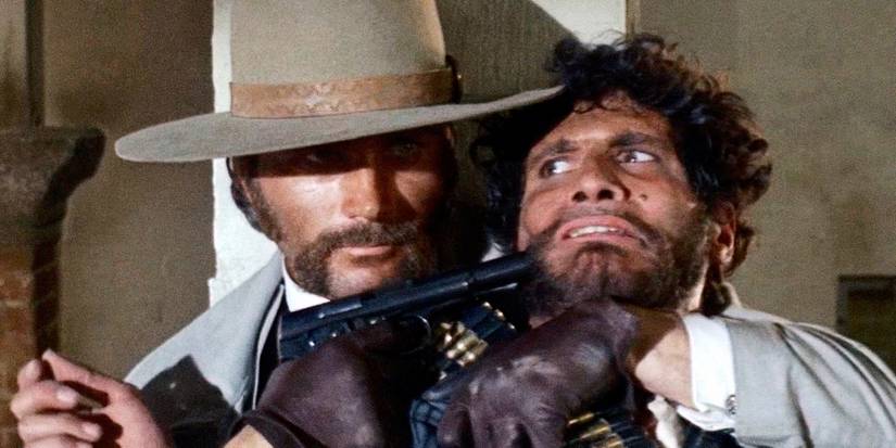 Frank Nero taking someone hostage with a gun in The Mercenary (1968)