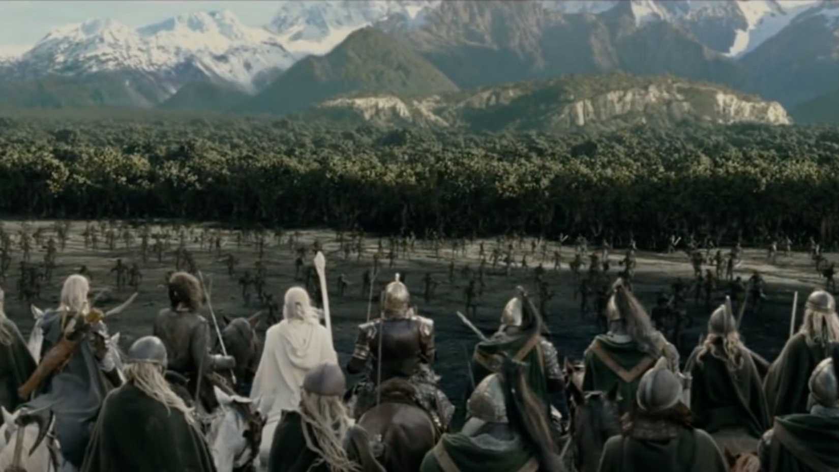 Gandalf alongside others watching uruk hai flee into fangorn forest in lord of the rings the two towers