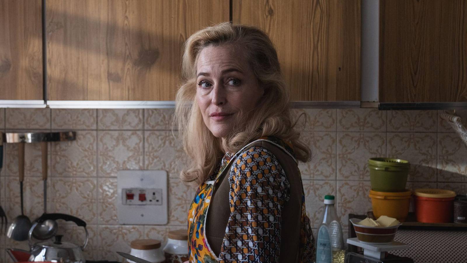 Gillian Anderson looks over her shoulder in the kitchen in Trespasses
