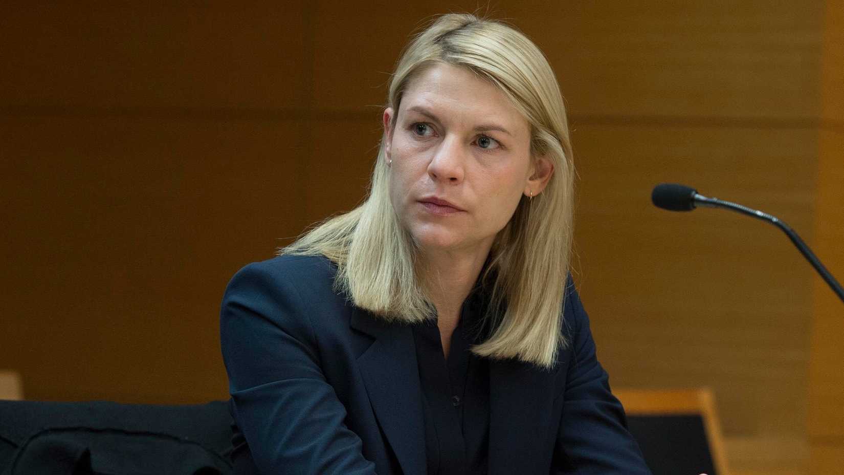 Claire Danes as Carrie Mathison sitting in front of a microphone in Homeland season 6