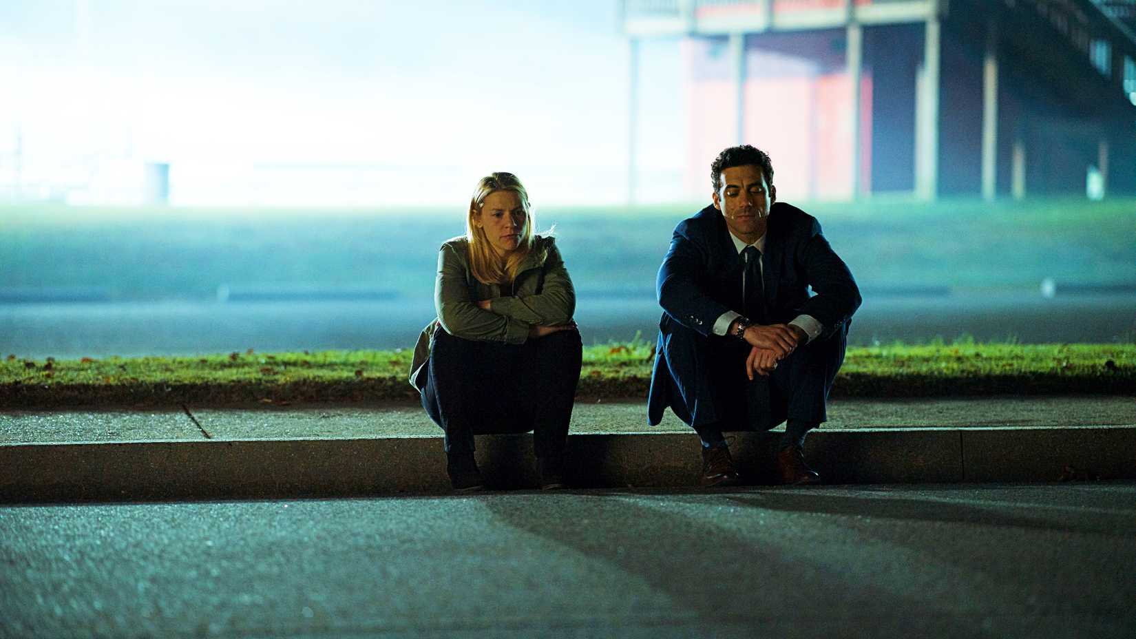 Claire Danes and Morgan Spektor sitting on a sidewalk in Homeland season 7