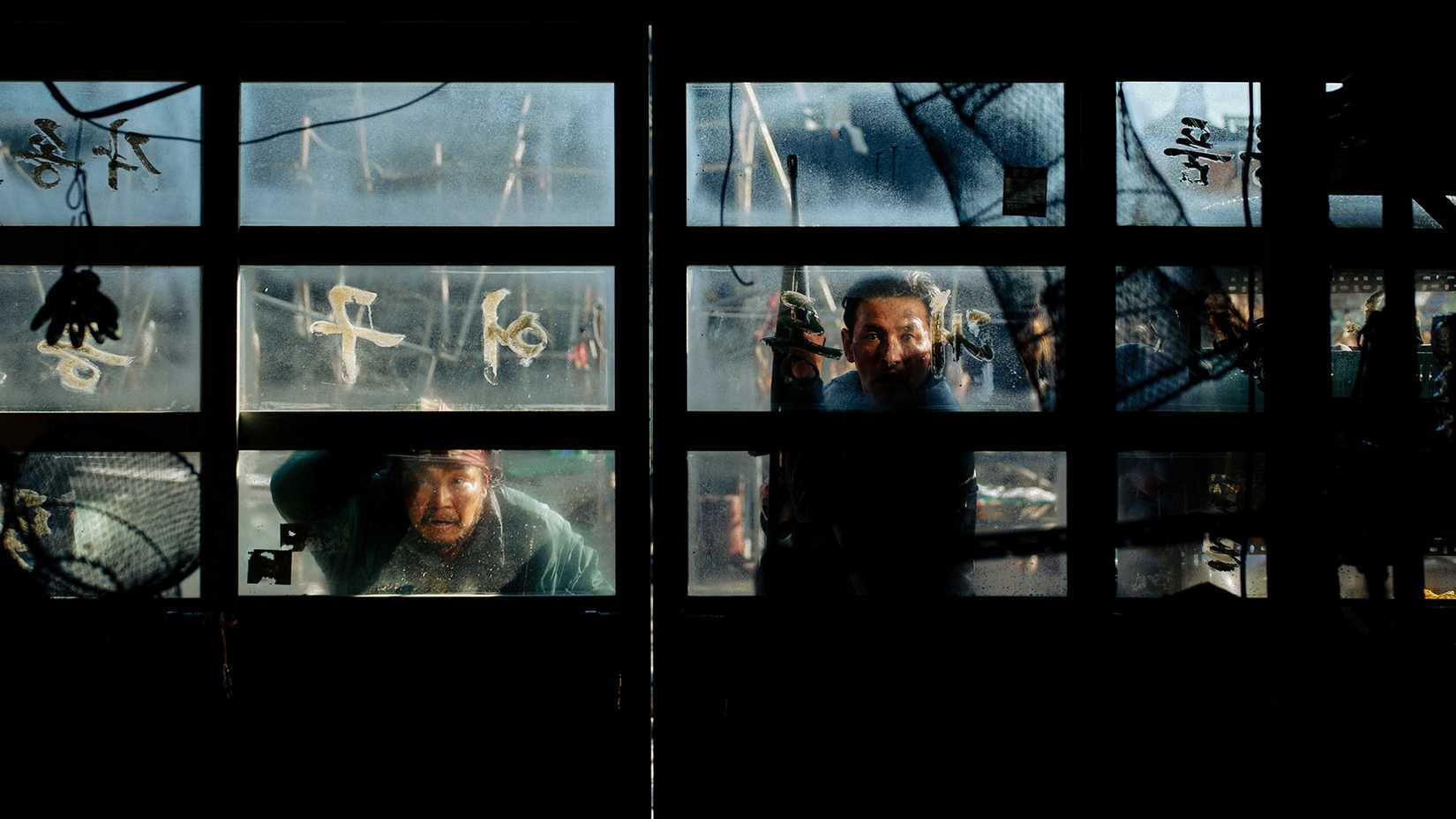 Hwang Jung-min looking through a window in Hope
