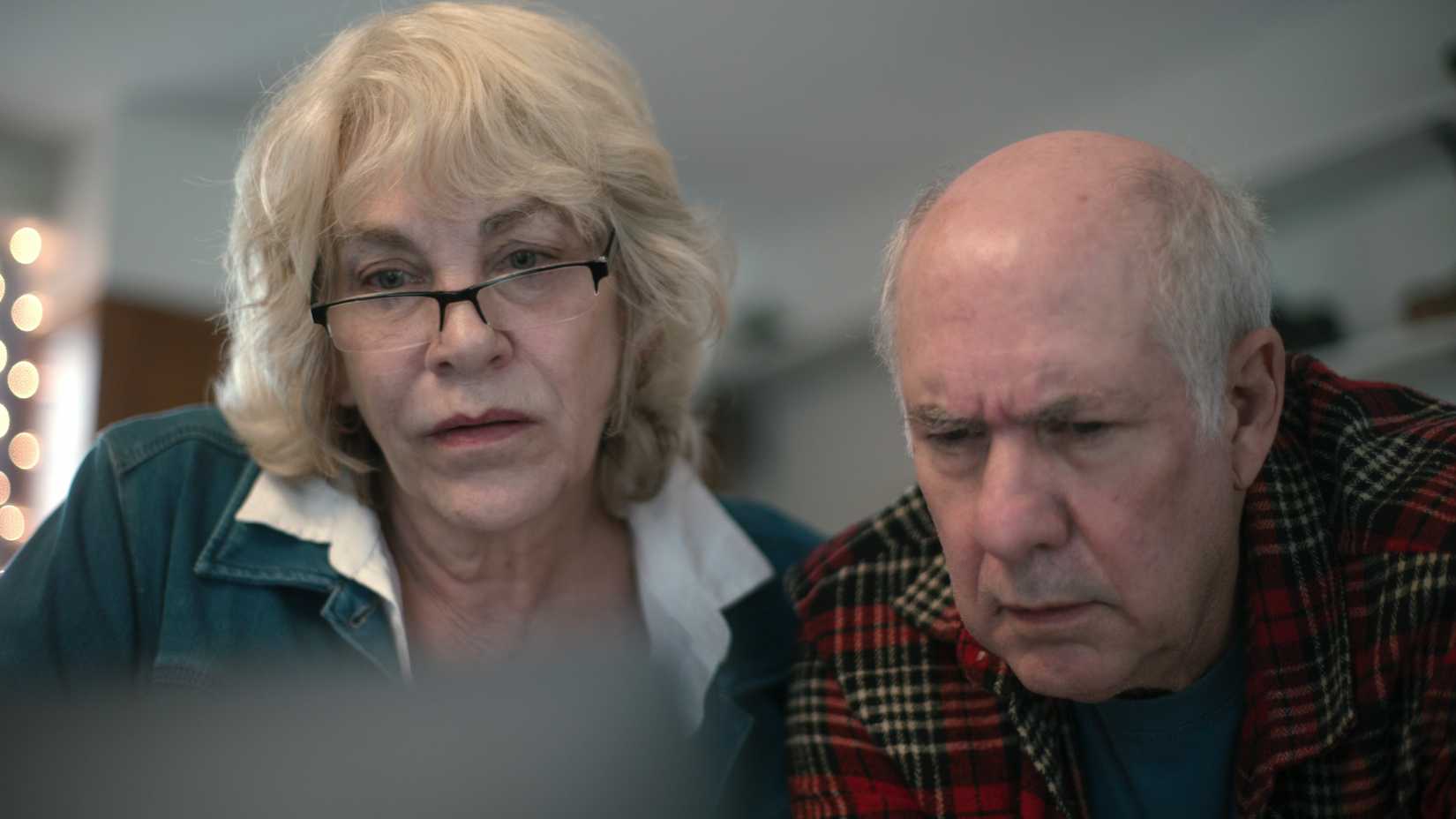 A man and woman look serious in the Netflix documentary Into the Fire: The Lost Daughter.