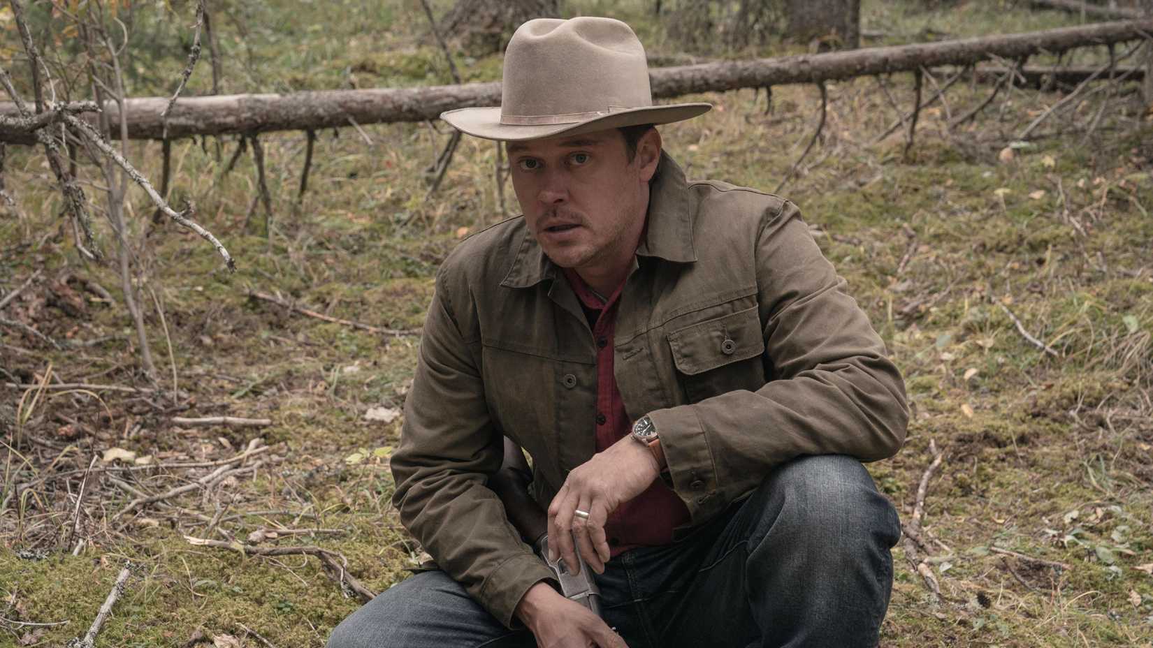 Joe Pickett (Michael Dorman) squatting down and looking at something.