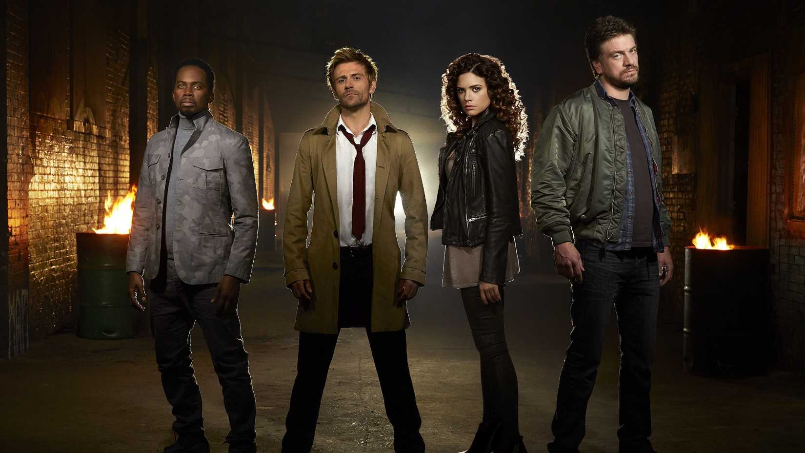 John Constantine and his team stand in a dark alley in the TV show Constantine