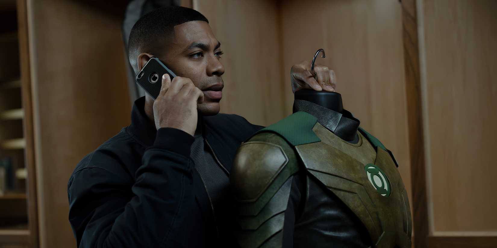 John holding Hal's costume in Lanterns