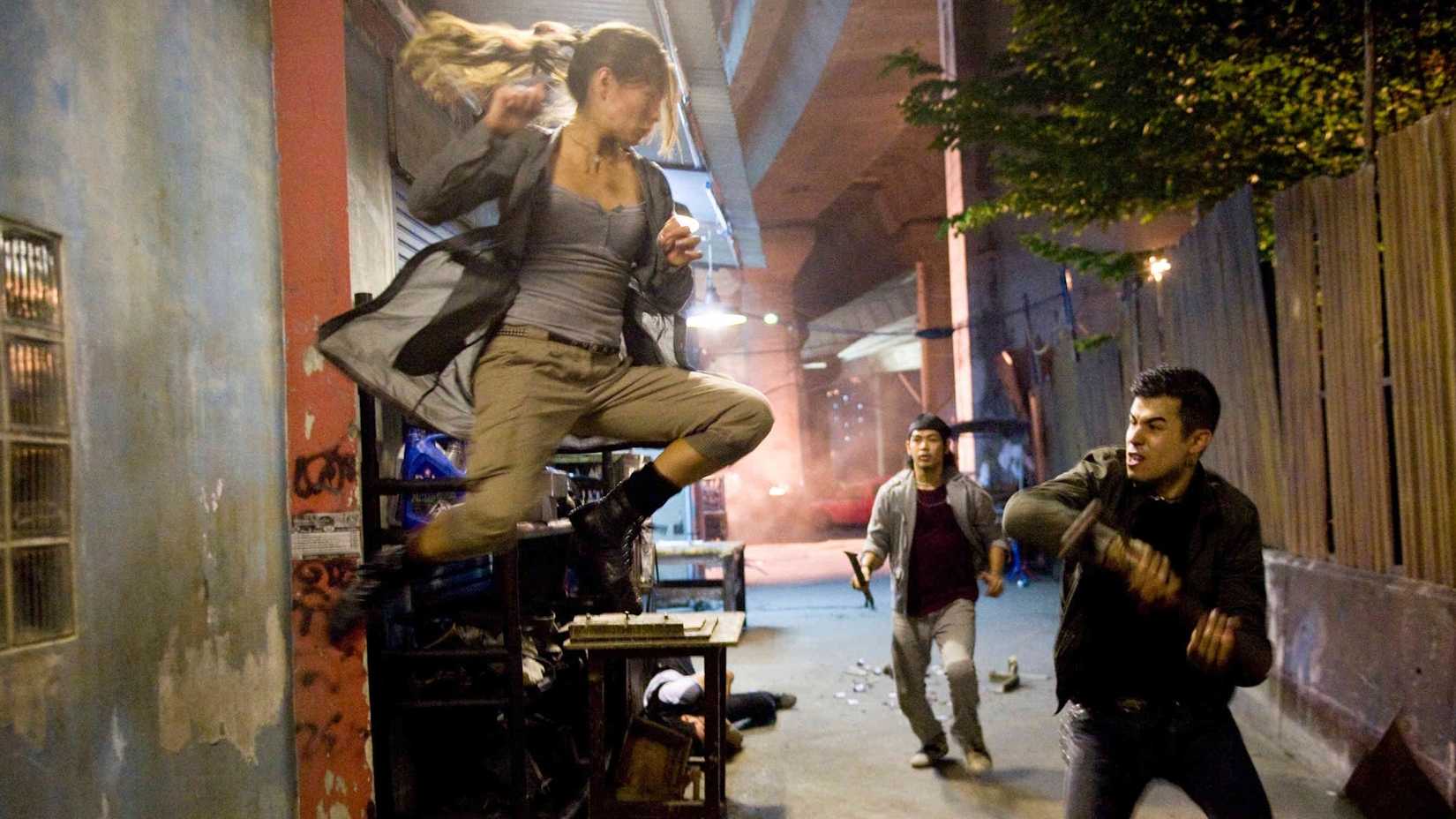 Kristin Kreuk as Chun Li attacking henchmen in street fighter the legend of chun li