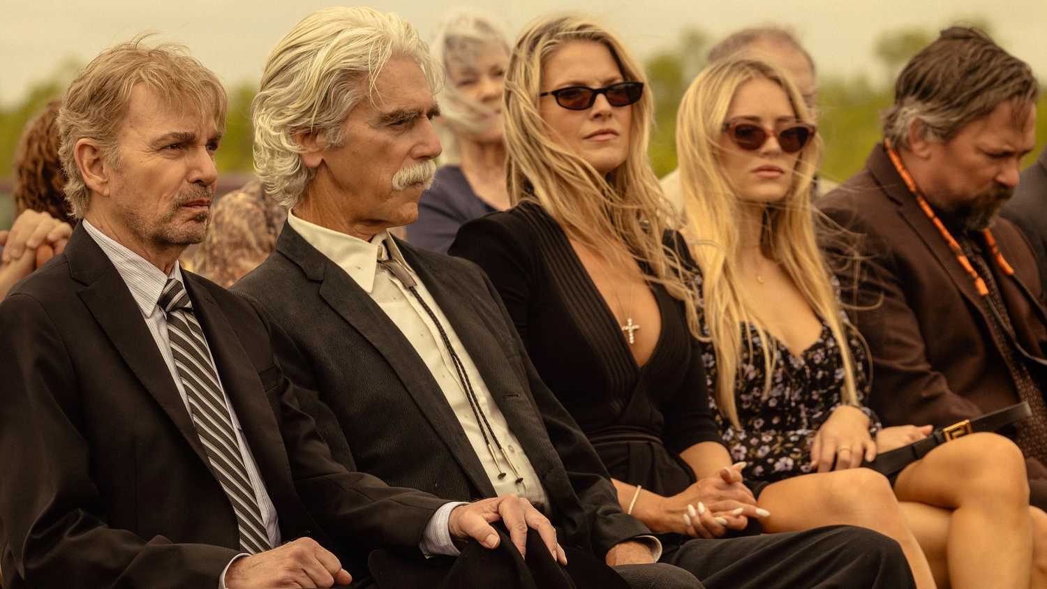 The cast of Landman at a funeral