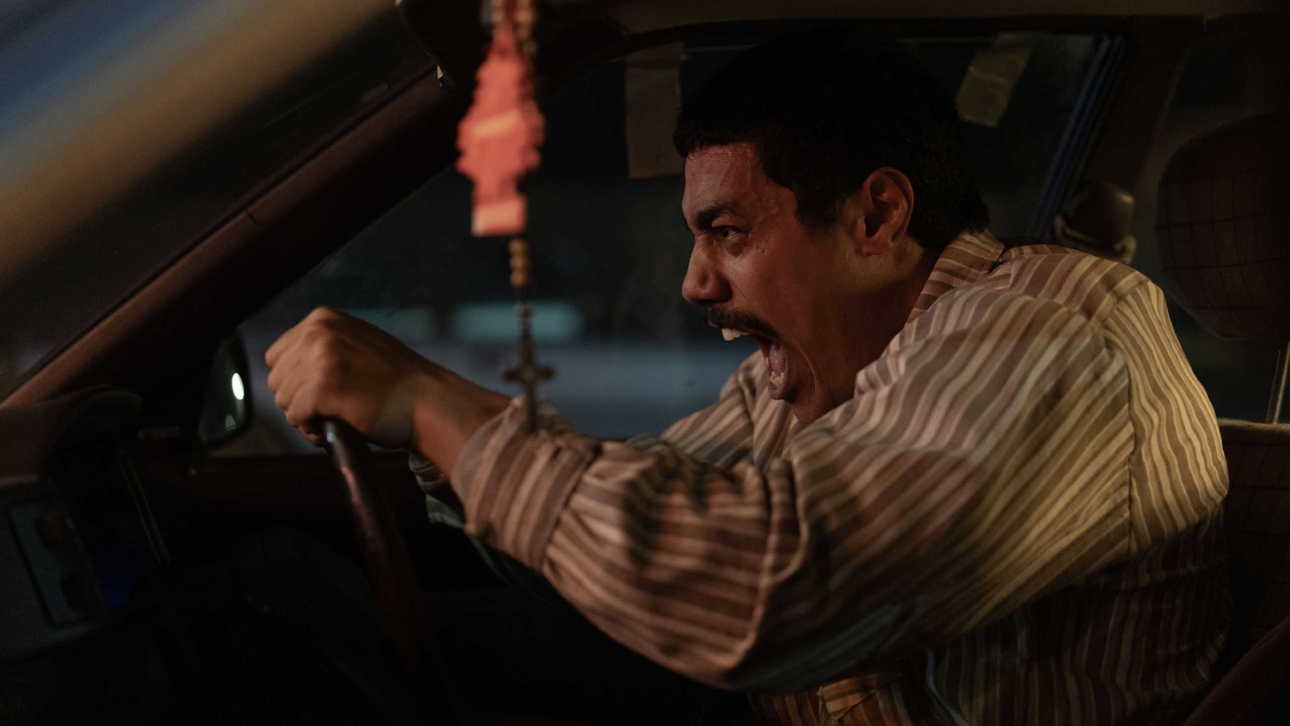 Mafu yelling behind the wheel of his car in God Bless You, Mr. Kopu