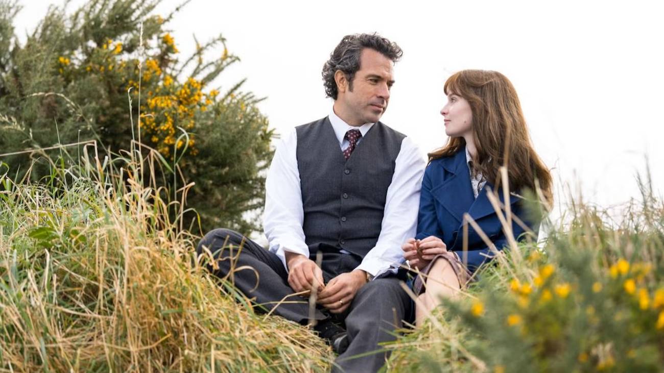 Michael and Cushla sit on a hill looking at each other in Trespasses
