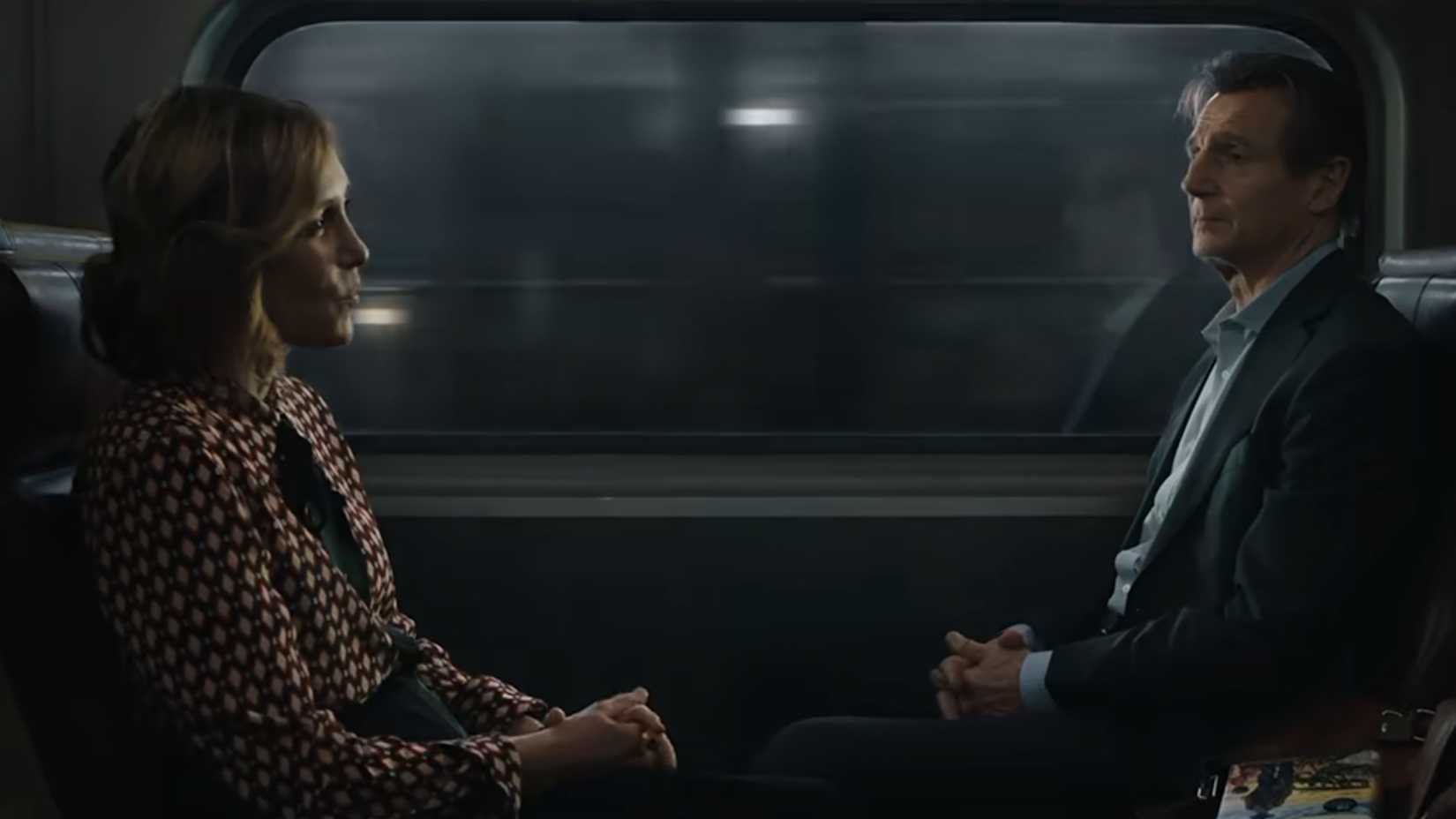 Michael listening to Joannas pitch in The Commuter