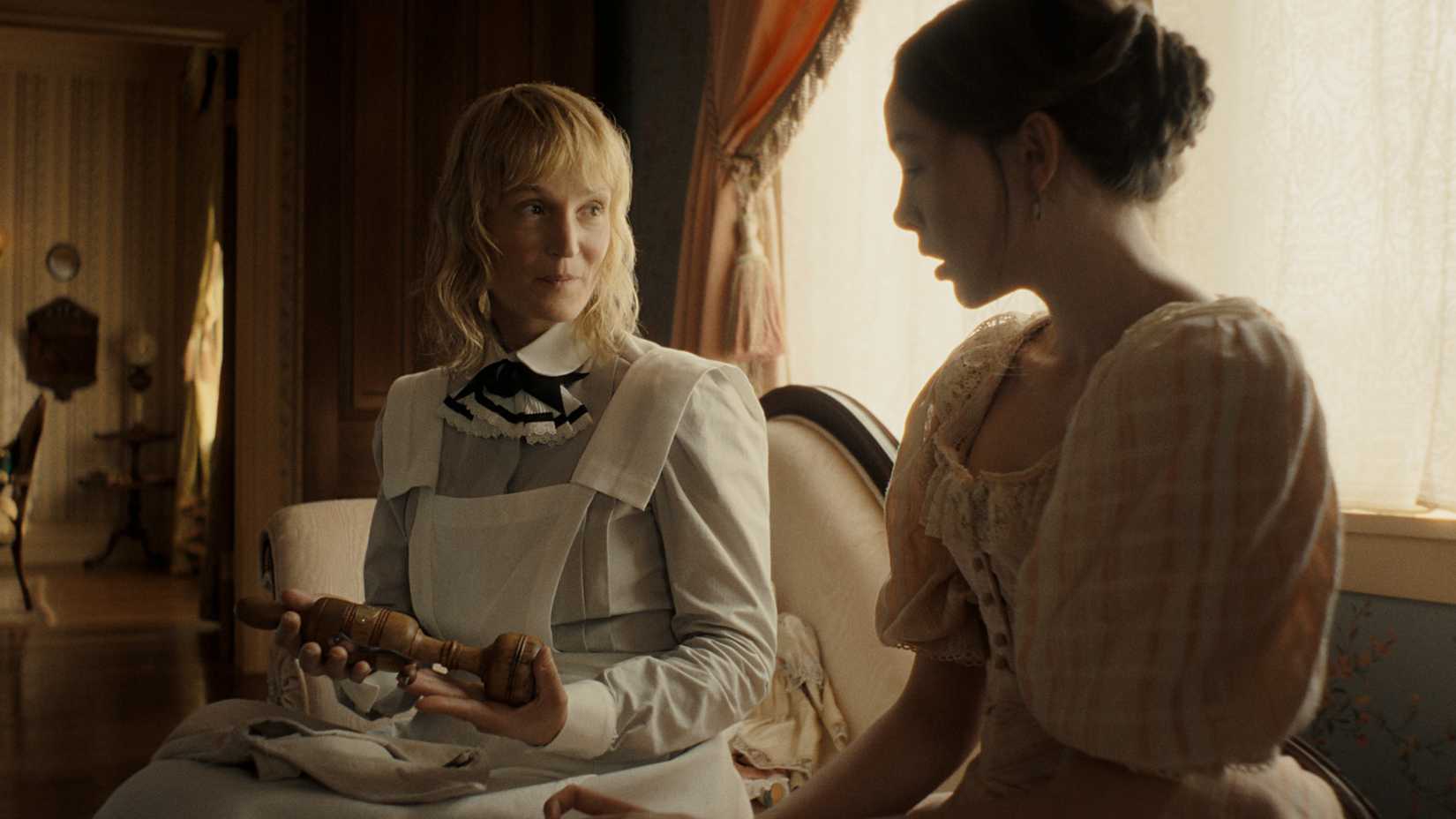Bridget and Lizzie Borden sit together in Monster: The Lizzie Borden Story