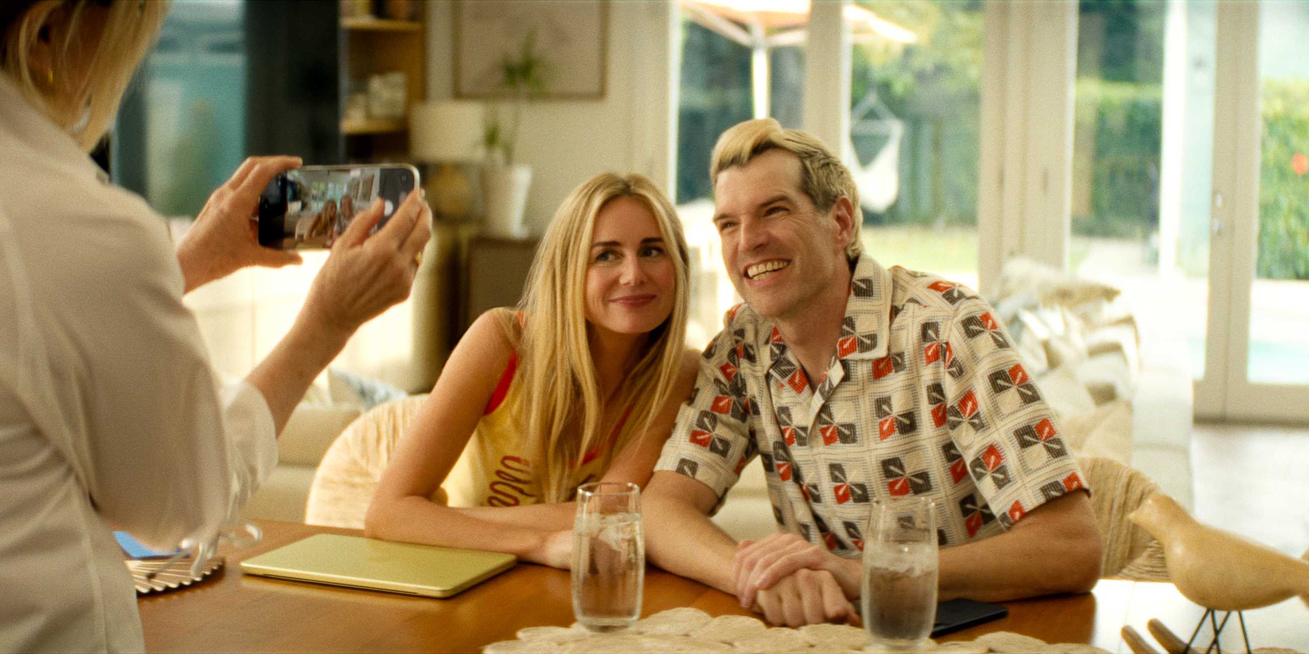 Morgan and Sasha smiling and taking a picture together in Nobody Wants This season 3