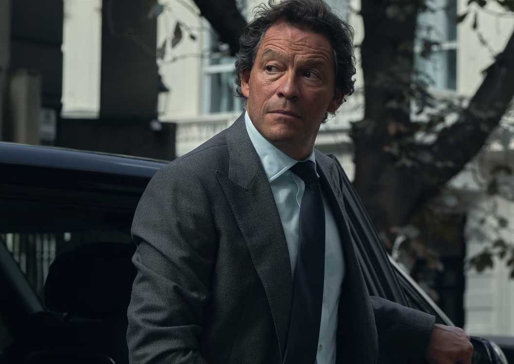 Morgan stands outside a car looking to the side in HBO's War