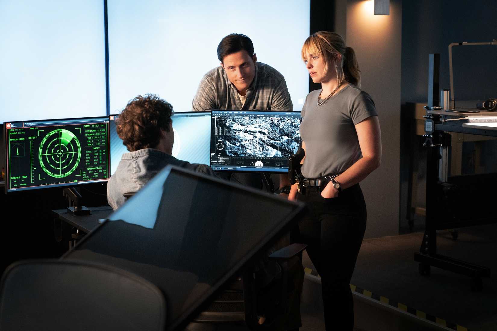 Wyatt Sellers, Addy Ross, and Sean Sullivan at Sean's computer workstation.