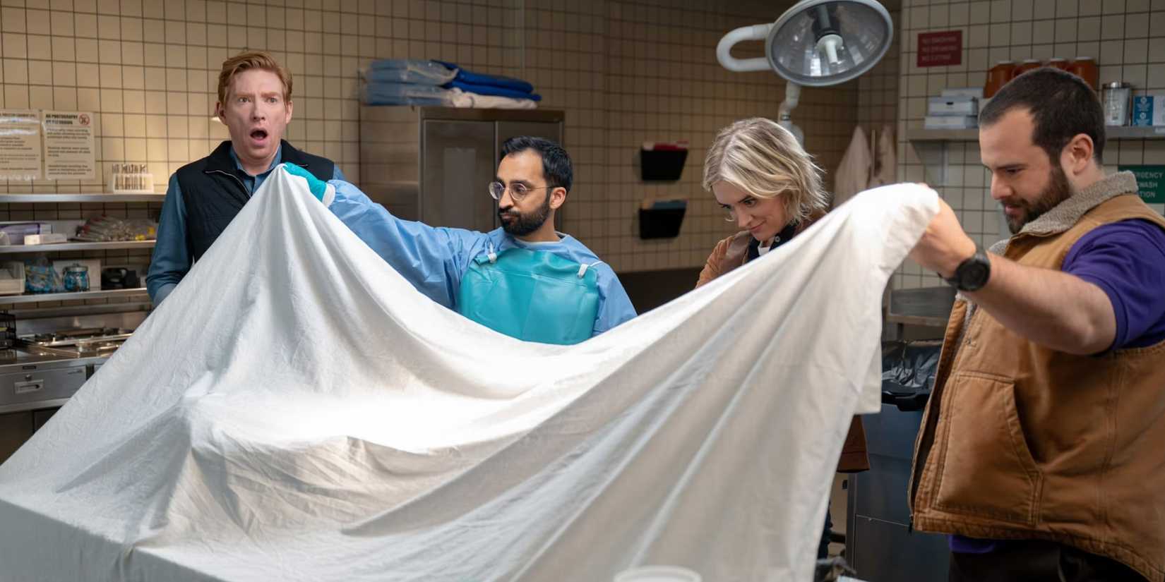 Ned, Mare, and Travis being shown a body at a morgue in The Paper