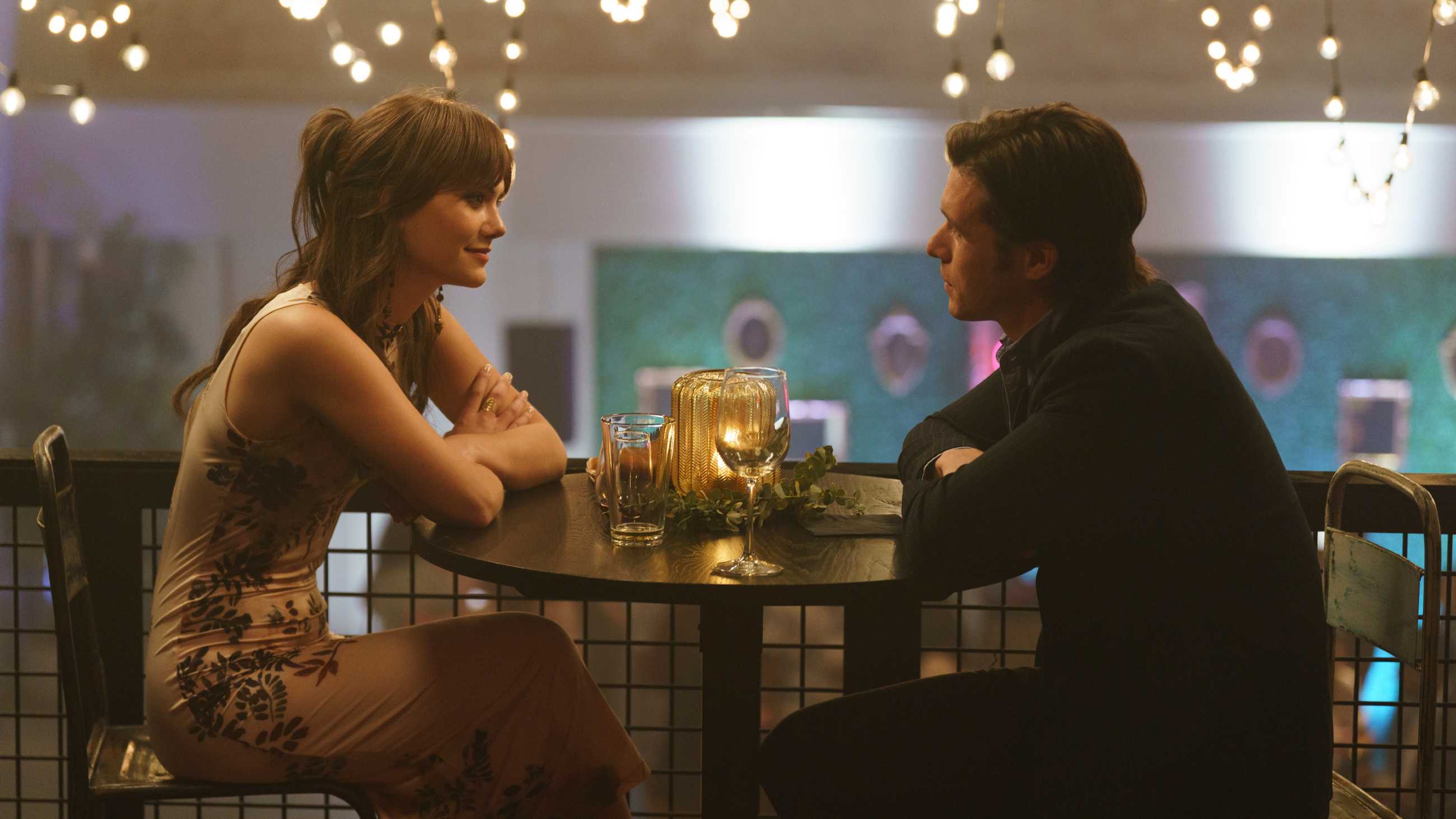 Older Charlie and Harper sitting at a table in fancy dress