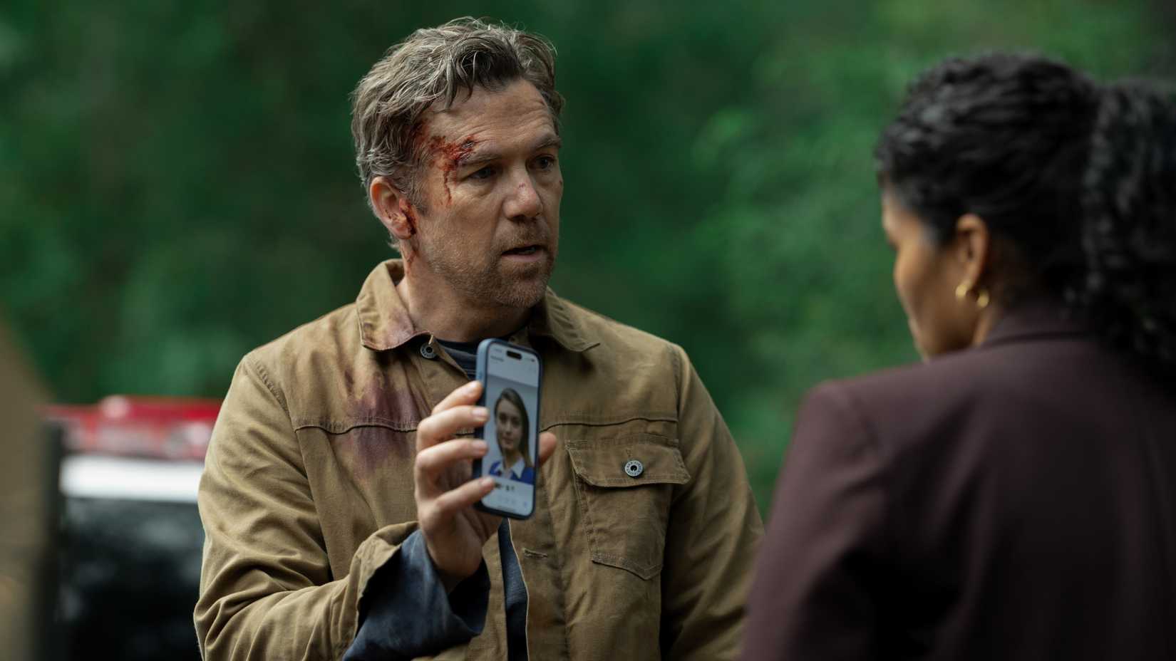 Patrick Brammall holding up his phone in Last Seen