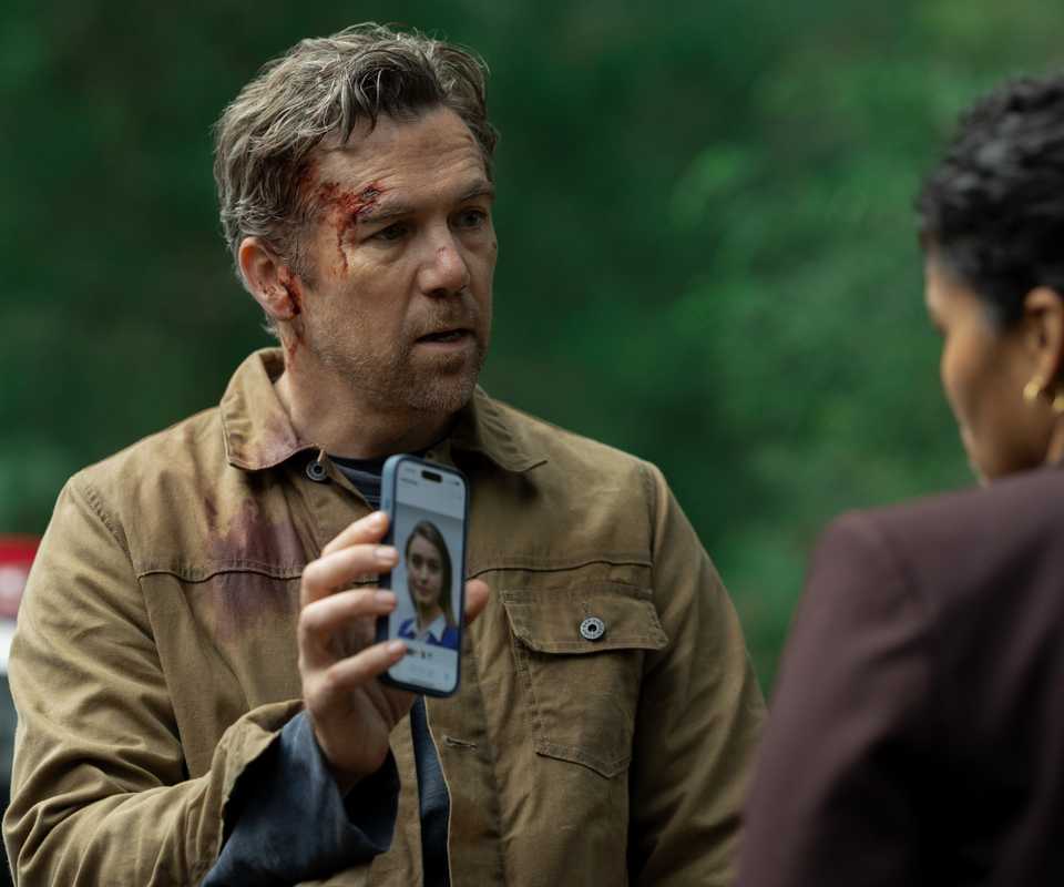 Patrick Brammall holding up his phone in Last Seen