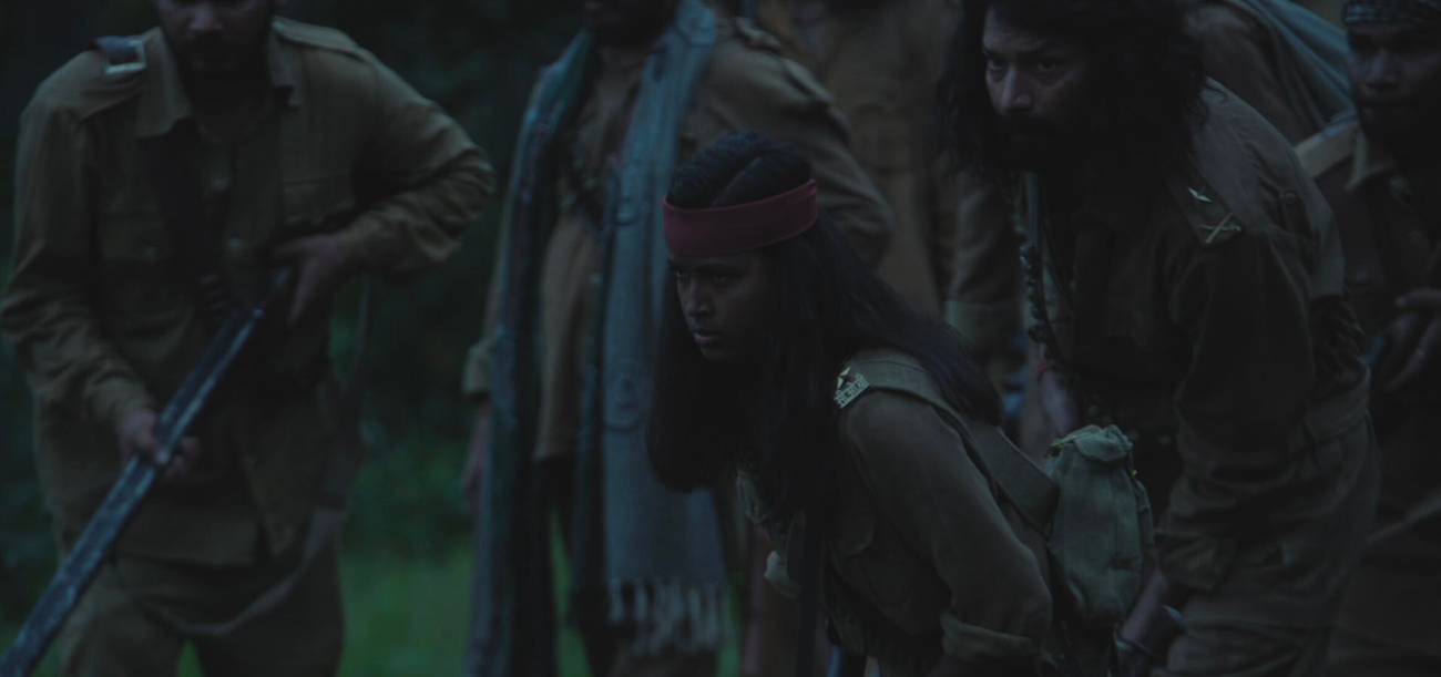 Phoolan and a group of bandits crouched and ready