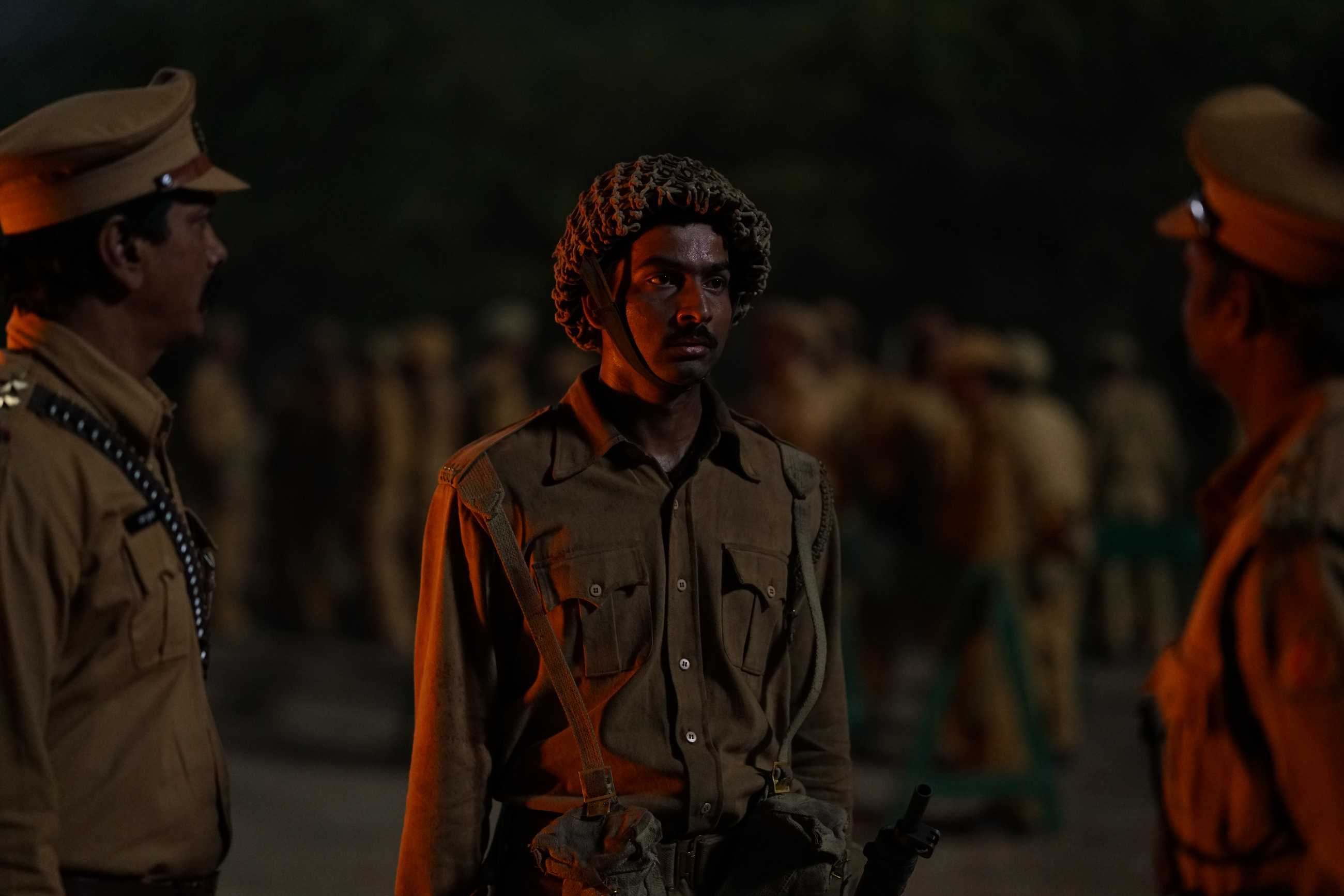 Soldiers standing around in the dark in Phoolan