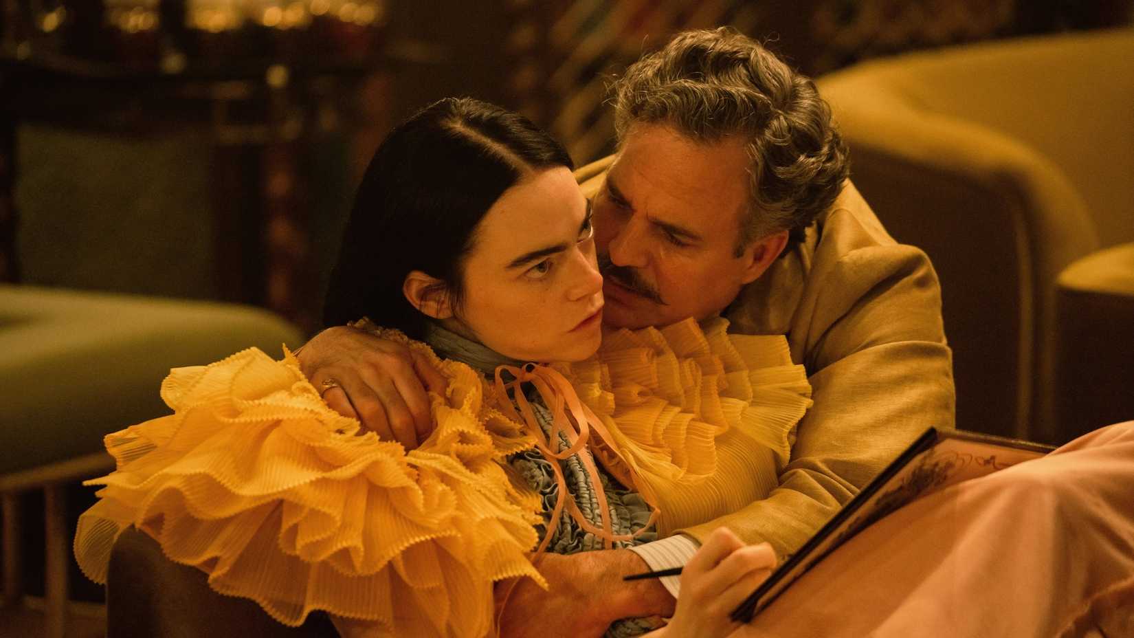 Duncan holding Bella close to him while she's seated with a sketchbook