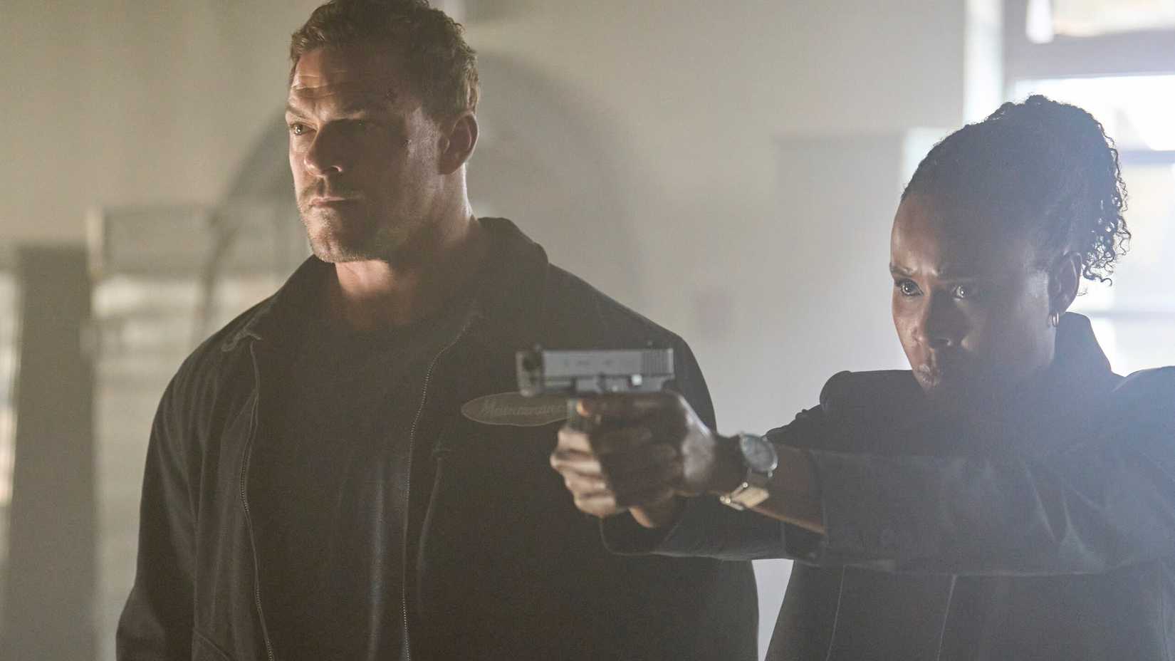 Reacher (Alan Ritchson) standing next to Tamara (Sydelle Noel) who is holding a gun in Reacher season 4