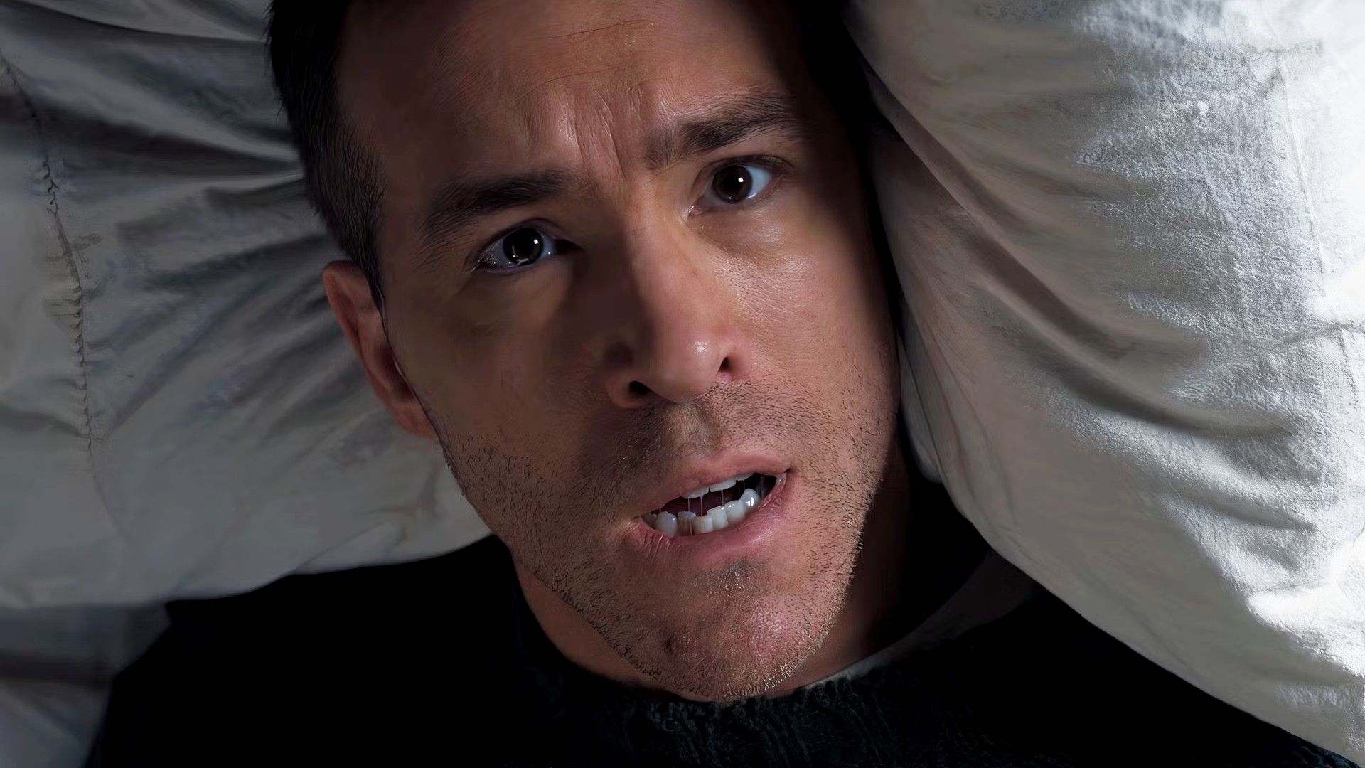Ryan Reynolds waking up from bed in Mayday